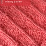 Twin Sails knit stitch pattern close-up in orange colored yarn.
