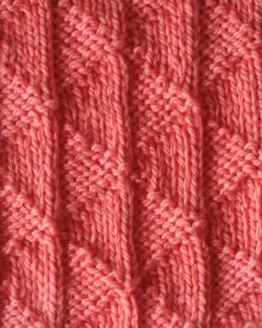 Twin Sails knit stitch pattern in orange colored yarn.