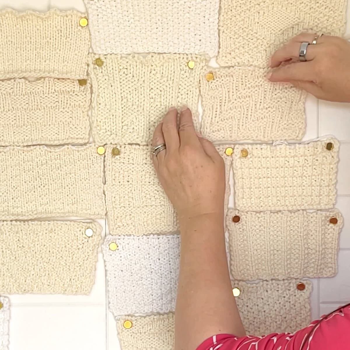 Pinning knit swatches to bulletin board.