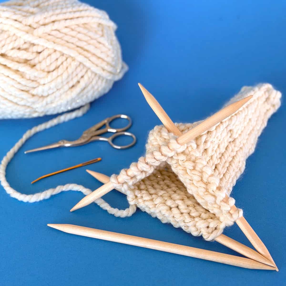 Knitting the tree shape in the round on double-pointed needles with super bulky yarn.