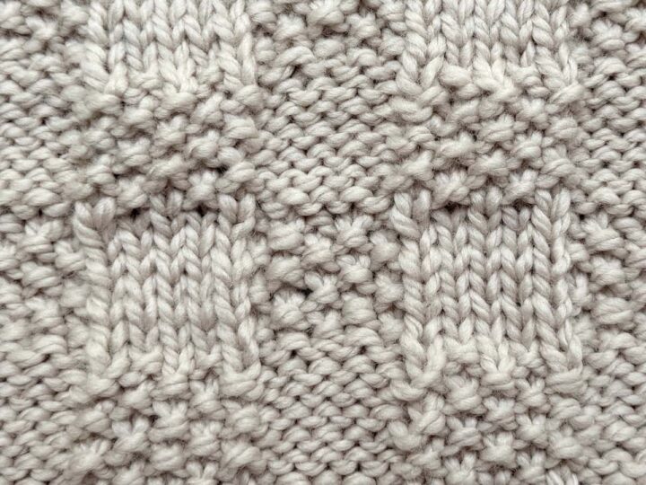 Close-up of Checkerboard Triple Weave Stitch swatch in ivory wool, showing smooth and bumpy checkerboard blocks.