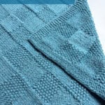 Create the Pescadero Harvest Blanket with this easy reversible knitting pattern. Its cozy checkerboard texture is knit in one piece with bulky-weight yarn, making it a relaxing project for baby blankets, lapghans, and throws. Printable pattern and yarn kit details from Studio Knit.